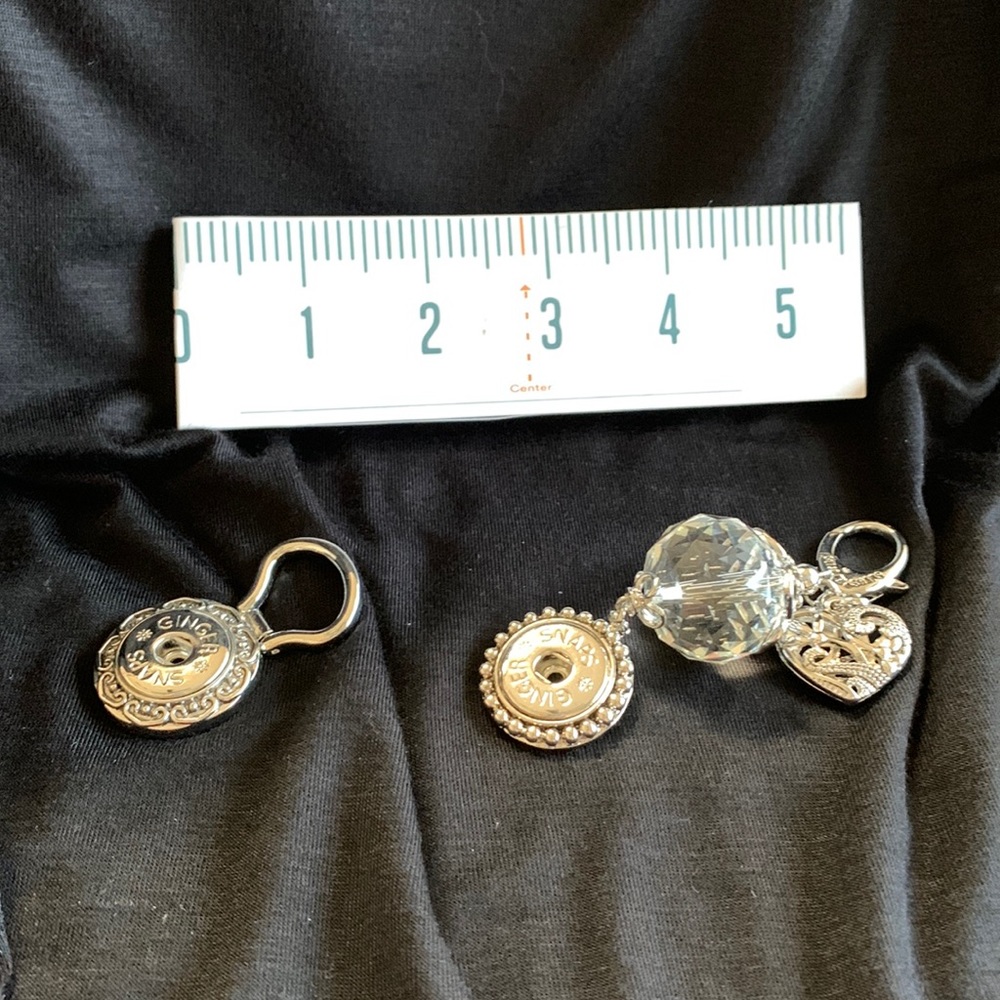 One silver tone snap key rings with changeable snap Medallion . NWOT